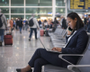 Woman at airport laptop phone